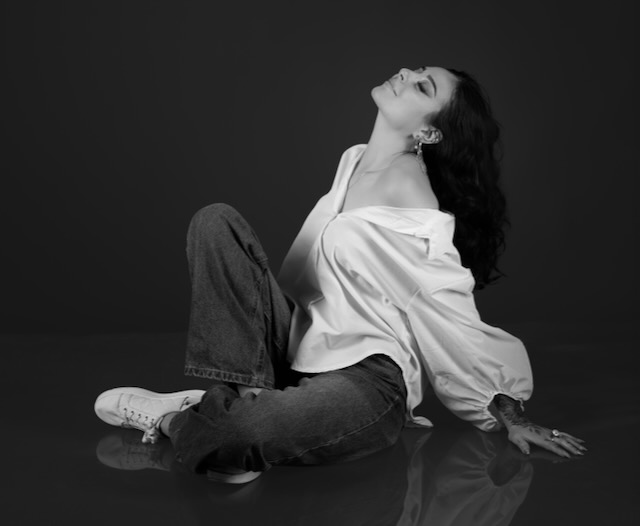 Monochrome seated portrait in a white shirt